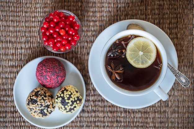 Spice tea consisting of cinnamon black pepper cardamom star anise lemon cloves and hot apple juice Close up top view