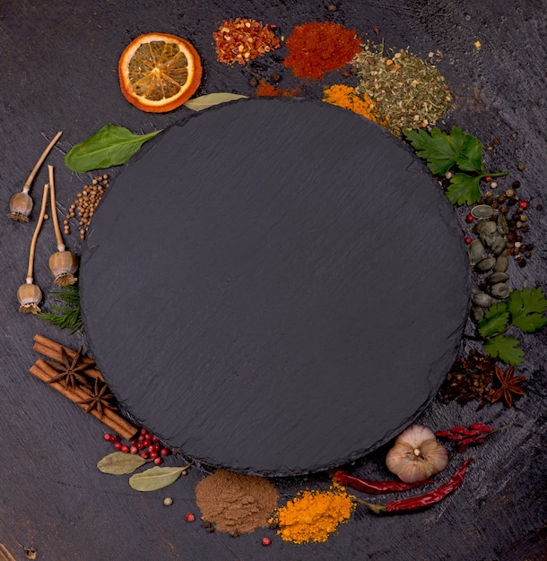 Spices and condiments for cooking on a black background.