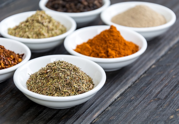 Spices and herbs in  bowls.