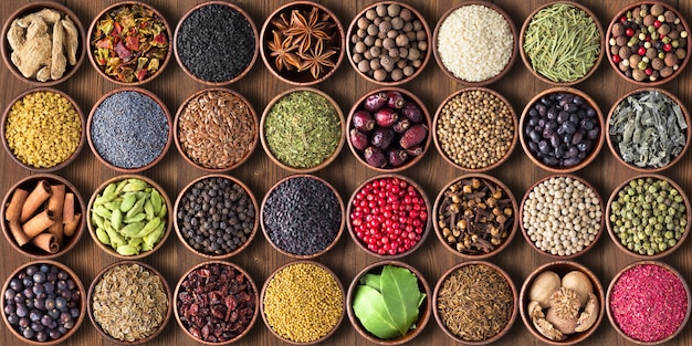 Spices and herbs in cups. colorful seasonings wallpaper