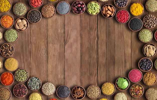 Spices and herbs on wooden bowls