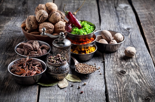 Spices and nuts at wooden table