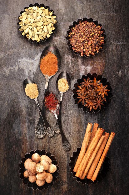 Spices and spicy in the spoons and metal cups top view