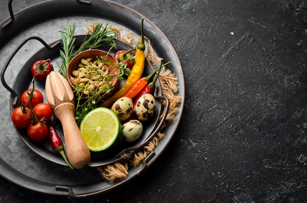 Spices vegetables and herbs on a metal tray Food background Top view Rustic style