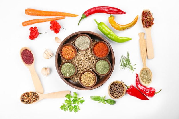 Spices, vegetables and herbs on white background