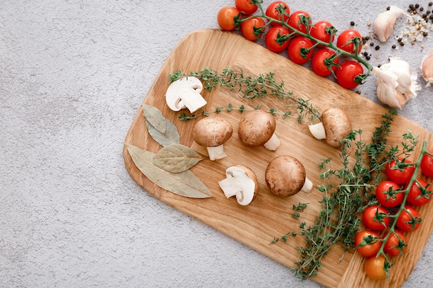 Spices and vegetables on light grey table background top view