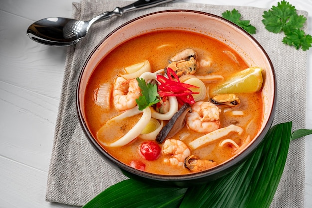 Spicy Asian tom yum soup with shrimp squid mussels and vegetables Asian cuisine