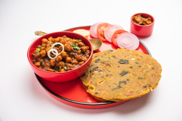 Spicy chickpea masala or chole curry with Pyaj Paratha or Spring Onion Parantha and mango pickle