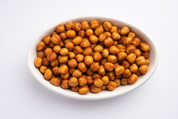 Spicy crispy roasted chickpeas with paprika, curry and hot chili pepper, selective focus