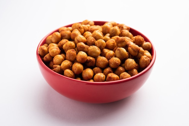 Spicy crispy roasted chickpeas with paprika, curry and hot chili pepper, selective focus