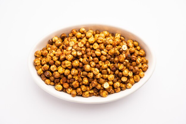 Spicy crispy roasted or fried chickpeas or futana with paprika, selective focus. Tasty popular vegetarian snack or side dish or chakna consumed with cocktail drinks