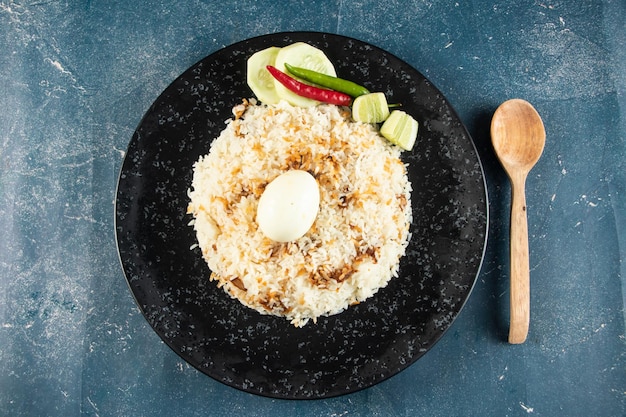 Spicy Egg pulao polao biryani mandi kacchi with egg and salad served in dish isolated on table top view of indian food