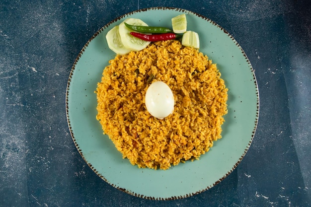 Spicy Egg pulao polao biryani mandi kacchi with egg and salad served in dish isolated on table top view of indian food