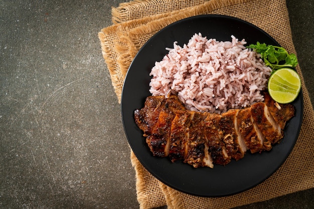 spicy grilled Jamaican jerk chicken with rice - Jamaican food style