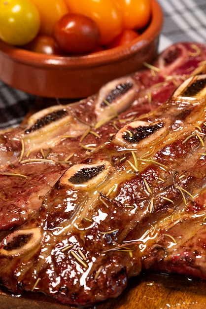 Spicy grilled spare ribs on cutting board close up