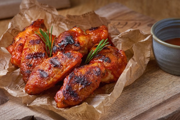 Spicy hot chicken wings cooked with honey and soy closeup on a rustic wooden background