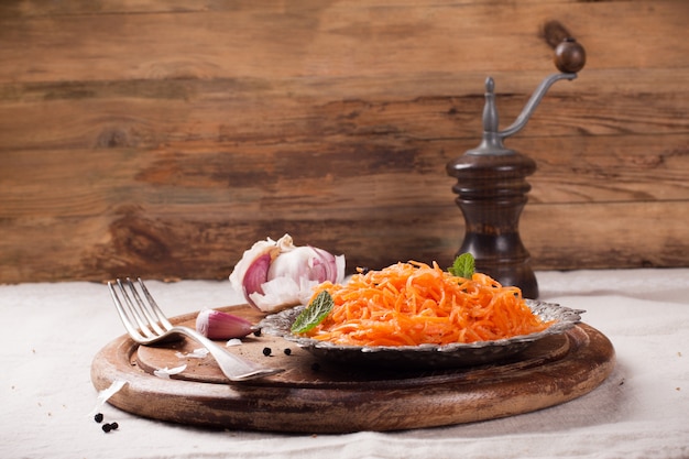 Spicy Korean style carrot salad on metal plate 