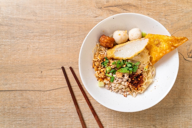 spicy noodles with fish ball and minced pork (Tom Yum Noodles) - Asian food style