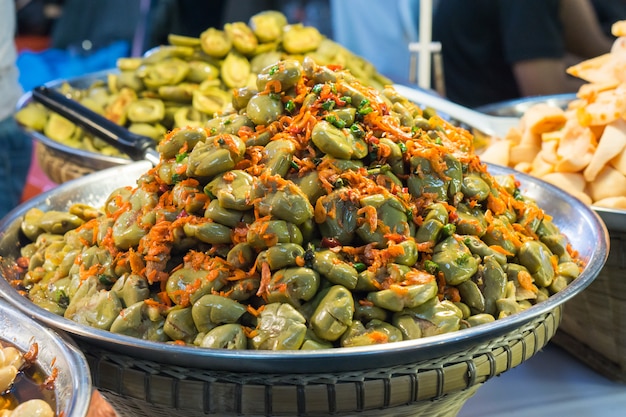 Spicy pickled madan with chili. Garcinia or madan preserves for snack.