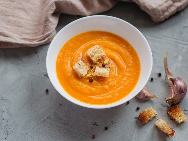 Spicy pumpkin soup with croutons and pumpkin seeds.