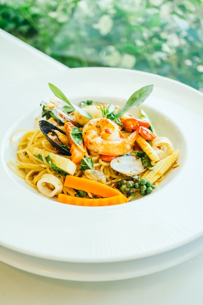 Spicy seafood spaghetti or pasta in white plate