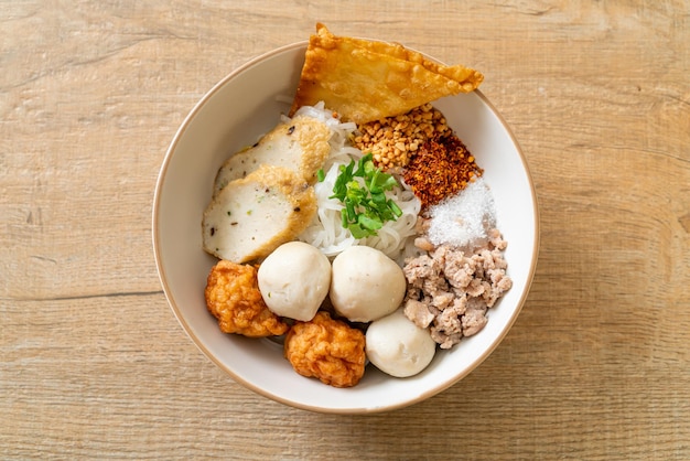 Spicy small flat rice noodles with fish balls and shrimp balls without soup