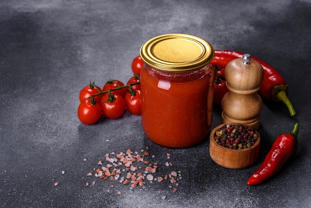 Spicy sweet tomato sauce with garlic pepper and herbs in a glass jars