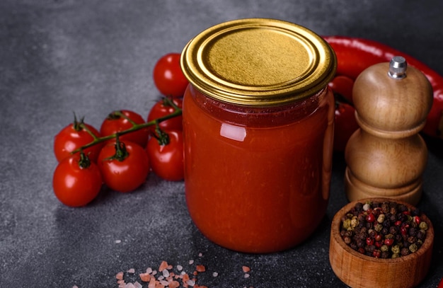 Spicy sweet tomato sauce with garlic pepper and herbs in a glass jars