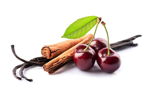 Spicy with cherry on white backgrounds. Cherry and cinnamon with vanilla pods isolated on white backgrounds.