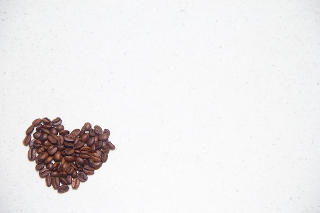 Spilled coffee beans. Coffee in the form of hearts. Coffee beans on the table