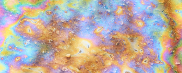 spilled gasoline rainbow background, industrial hazard spill pollution, abstract texture multicolored