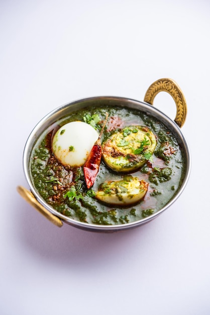 Spinach egg curry is an Indian non vegetarian dish made using palak gravy with eggs