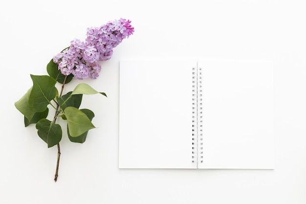 Spiral notebook and pen Notepad with pen and flowers Notebook lilacs on light background