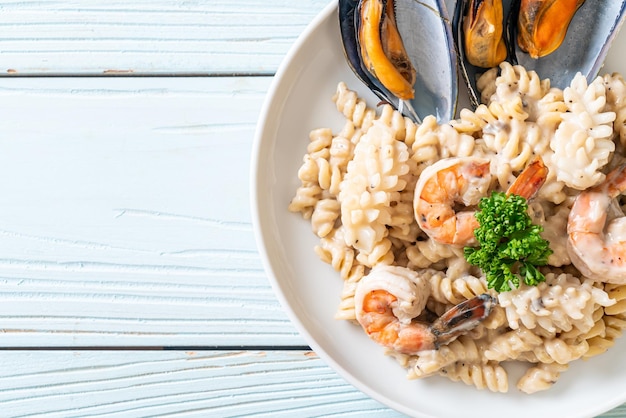 Spiral pasta mushroom cream sauce with seafood