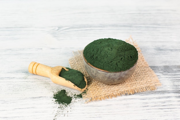 Spirulina algae powder in a bowl, alternative medicine for to detox, antioxidant food ingredients