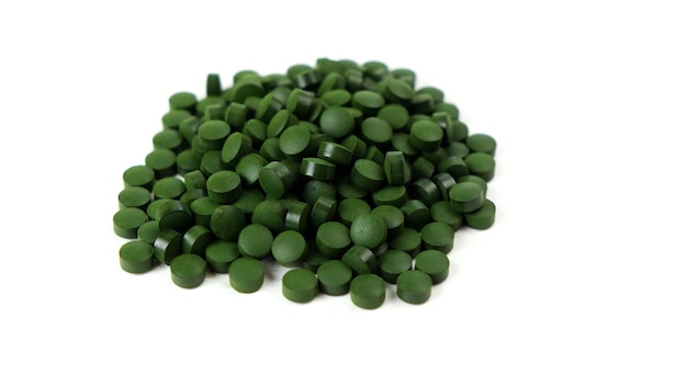 Spirulina algae tablets isolated on white background Nutritional supplements vitamins and health