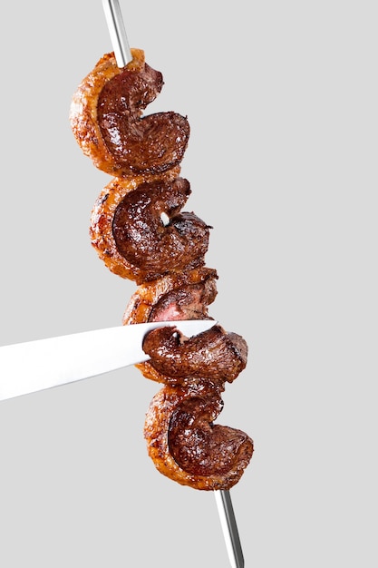 Spit roast sirloin in white background. Picanha barbecue.