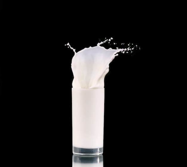 Splash in a glass with milk isolated on black