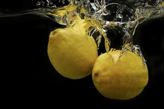 Splash of water with fruits lemon orange