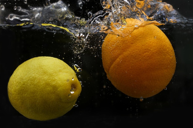 Splash of water with fruits lemon orange