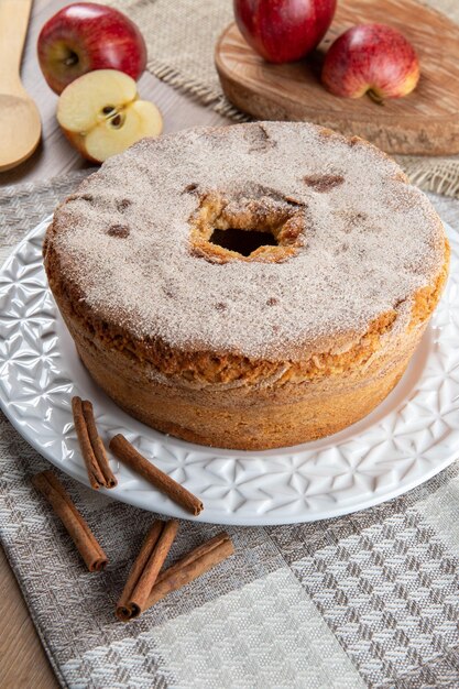 Photo sponge cake or chiffon cake with apples so soft and delicious sliced with ingredients cinnamon eggs flour apples on wooden table home bakery concept for background and wallpaper