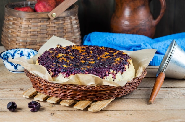 Sponge cake with frozen blueberries in a wicker plate rustic style