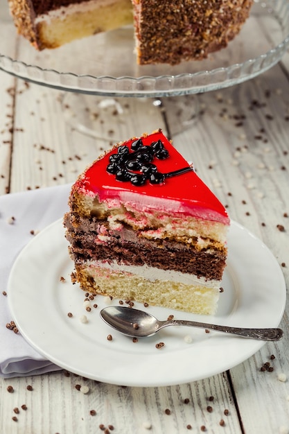 Sponge cake with fruit jelly on wooden background