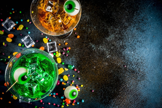 Spooky Halloween green, orange martini cocktails