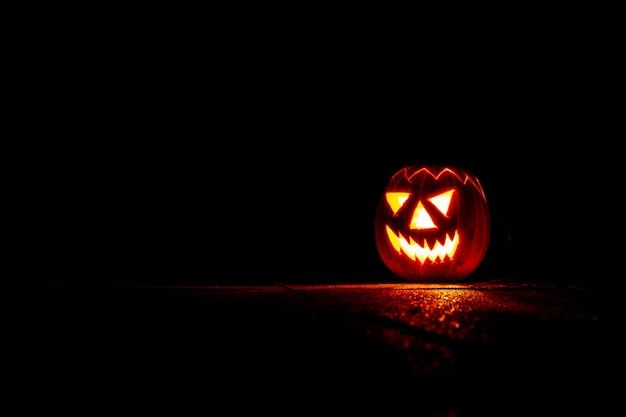 Spooky Halloween pumpkin lantern at night in the darkness