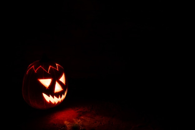 Spooky Halloween pumpkin lantern at night in the darkness