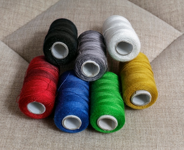 Spools of sewing thread with the primary colors of the photograph