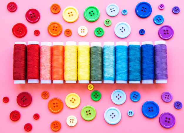 Spools of thread and buttons on the colors of the rainbow