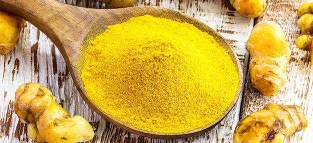 Spoon of curry or turmeric powder, macro photography