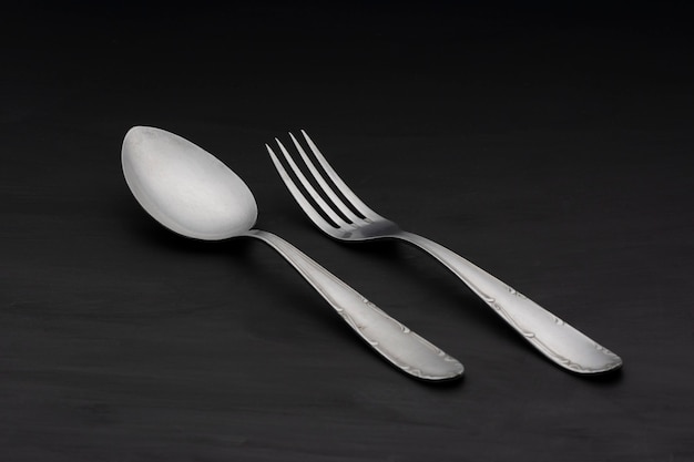 spoon and fork on black table